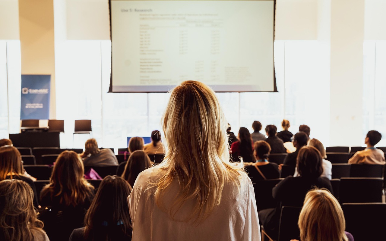 Audience watching a presentation at a large-scale event